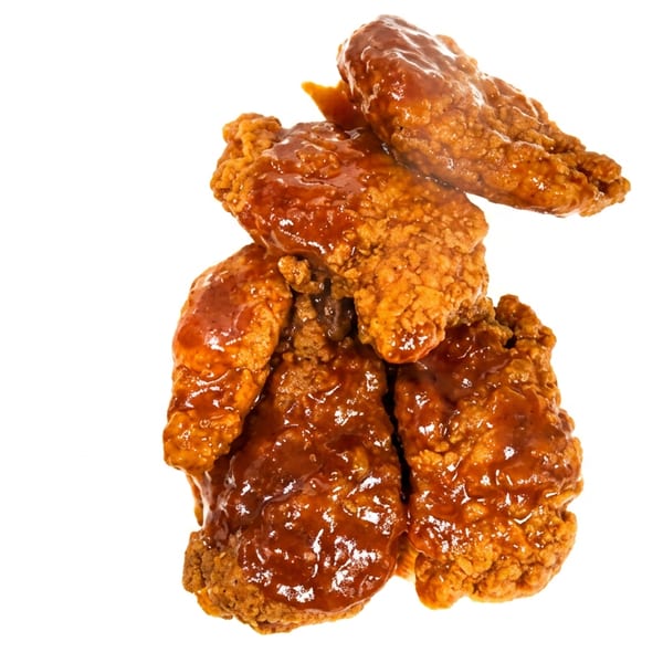 Crispy fried chicken tenders coated in a glossy, rich barbecue sauce, isolated on a white background.